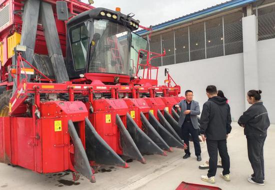 9月7日，兵团农业机械化主题展览馆暨新疆准葛尔银丰农机装备有限公司工作人员向媒体记者介绍棉花机发展历程。中新社记者 糟玉琴 摄